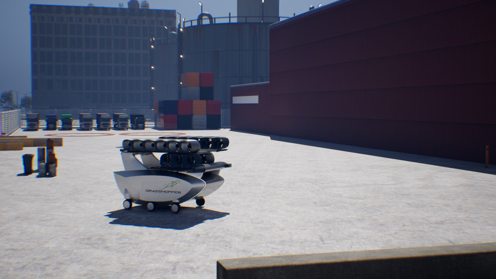 The e350 concept arriving at a logistics yard on its own wheels, past a line of parked trucks and stacked containers.